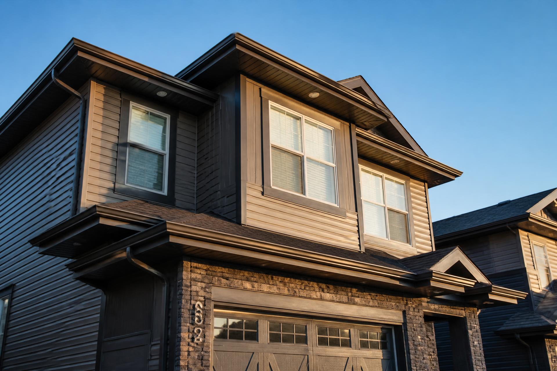 Newly installed seamless eavestrough on a Calgary home at golden hour